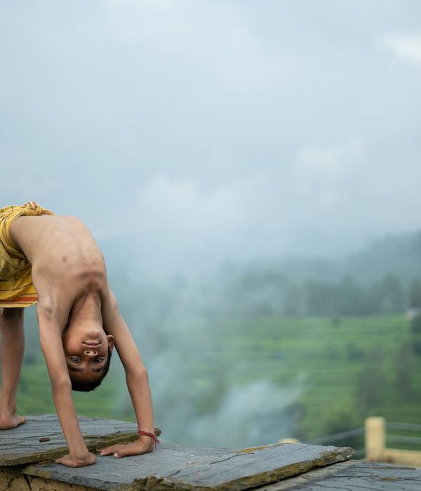 A person in an energetic yoga pose against a clean background.